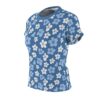 Light blue and white flowers fill this all over print apparel, set against a blue background with subtle texture.