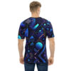Blues, purples, and pinks with geometric shapes like triangles, circles, and lines create a dynamic, abstract pattern across this tee shirt.