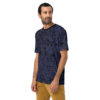 Thin blue lines and distressed black shapes cover this patterned tee shirt, creating a textured, abstract design.