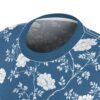 White floral branches and blossoms cover this seamless pattern tee, set against a deep blue background.