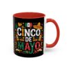 A black ceramic mug with a red interior and handle, decorated with colorful graphics of maracas, sombreros, Mexican flag, and text reading 