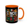 Black mug with orange interior and handle features colorful Cinco De Mayo graphics including a Mexican flag, sombrero, maracas, and bottles.