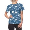 White floral vines and blossoms cover this all over print apparel, set against a rich blue background with delicate leaves.