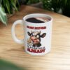 A grumpy cow with a daisy in its mouth and text that reads
