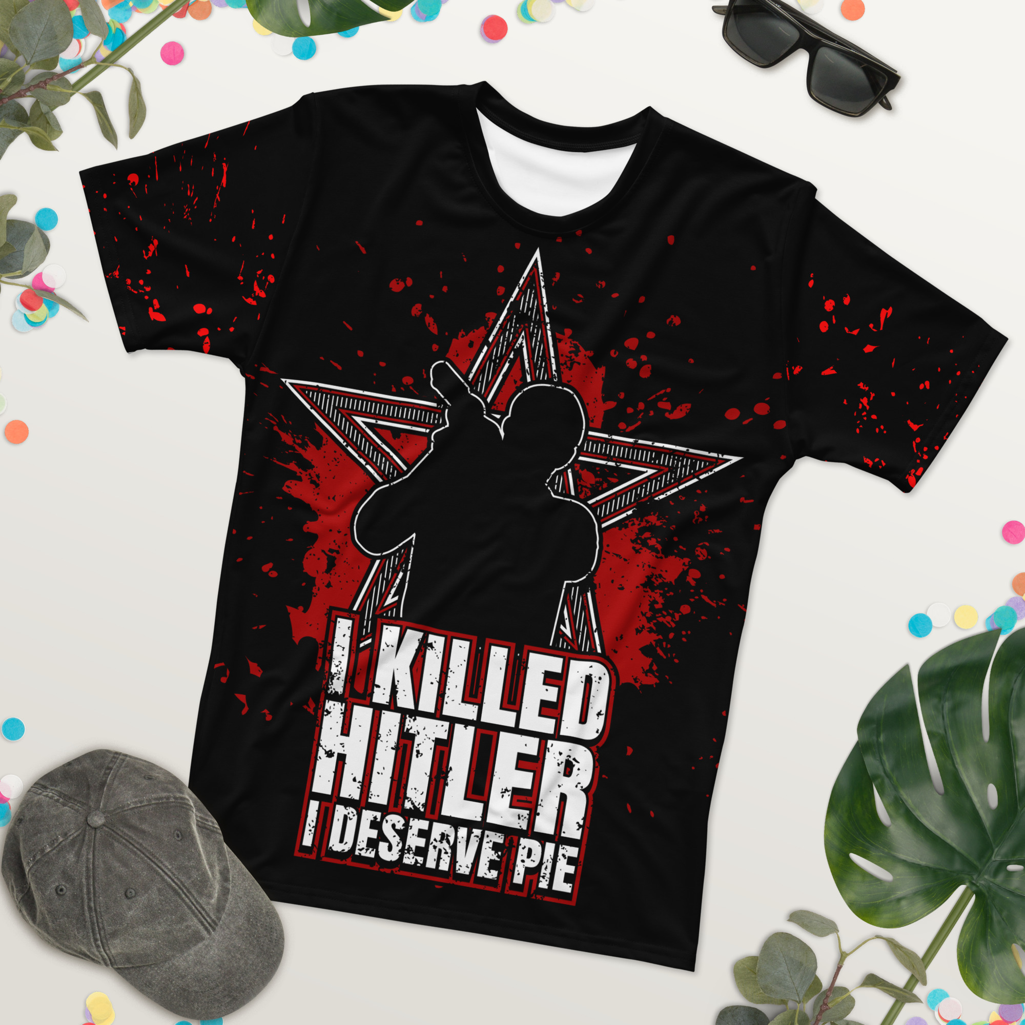 Red splatters and a distressed star design cover this patterned tee shirt, featuring a silhouette of a person and bold white text.
