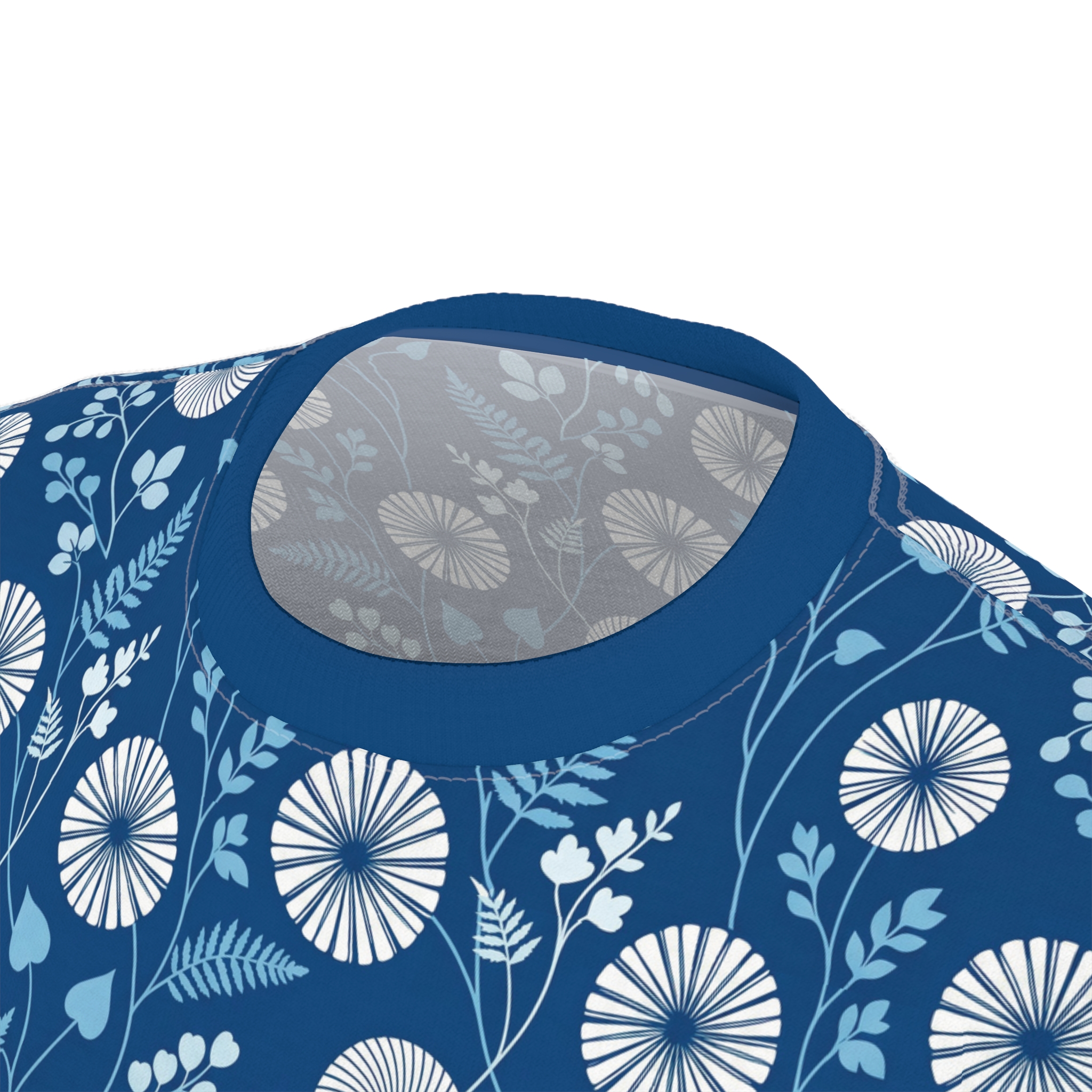 Deep blue tee with a white and light blue botanical print, featuring dandelion-like flowers and foliage. This is an all over print t-shirt.
