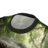 Lush green jungle foliage and a close-up of a chimp's textured fur cover this all over print t-shirt.