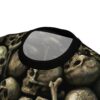 Eerie green-tinged skulls and bones form a dense pile across this all over print t-shirt.