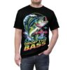 Bright blues, greens, and pinks cover this patterned tee shirt, depicting a jumping bass fish with waves and the words 