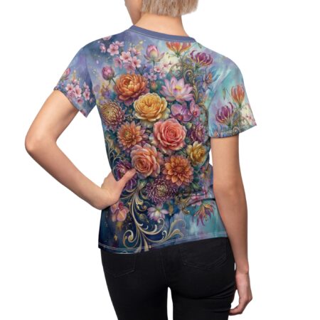 Vibrant floral all over print sublimation tee featuring pink roses, orchids, and lilies on a blue watercolor background with gold accents.