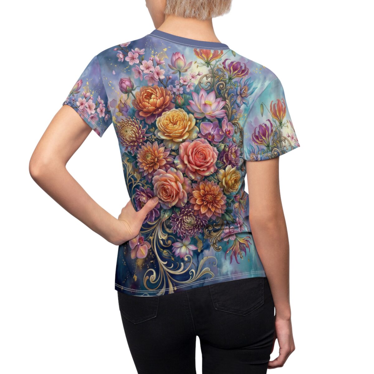 Vibrant floral all over print sublimation tee featuring pink roses, orchids, and lilies on a blue watercolor background with gold accents.
