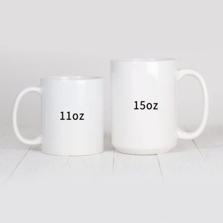 White ceramic coffee mugs displayed in 11oz and 15oz capacity sizes on a light wooden surface.