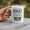 White ceramic mug with black text that says 