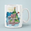White ceramic mug with a festive holiday graphic featuring a Christmas tree, snowman, hot cocoa, and snowflakes.