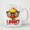 Glossy white ceramic mug displays a vibrant yellow duck graphic wearing black glasses, a white collar, and a red tie above bold distressed red and black text.