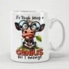 White ceramic mug with a cartoon cow wearing glasses and eating grass, text reads 