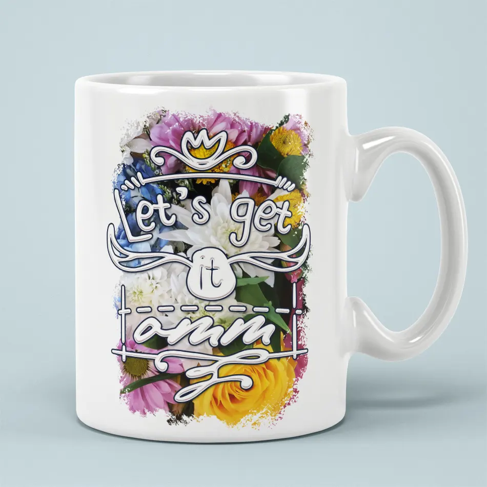 White ceramic mug with a vibrant floral design and the text "Let's get it omm" in stylized lettering.