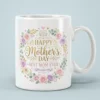 White ceramic mug with a floral wreath design and 