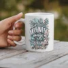 White ceramic mug with a crown design and text