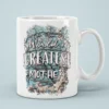 White ceramic coffee mug with a watercolor floral design and the words 