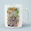 White ceramic coffee mug with a floral design and the text 