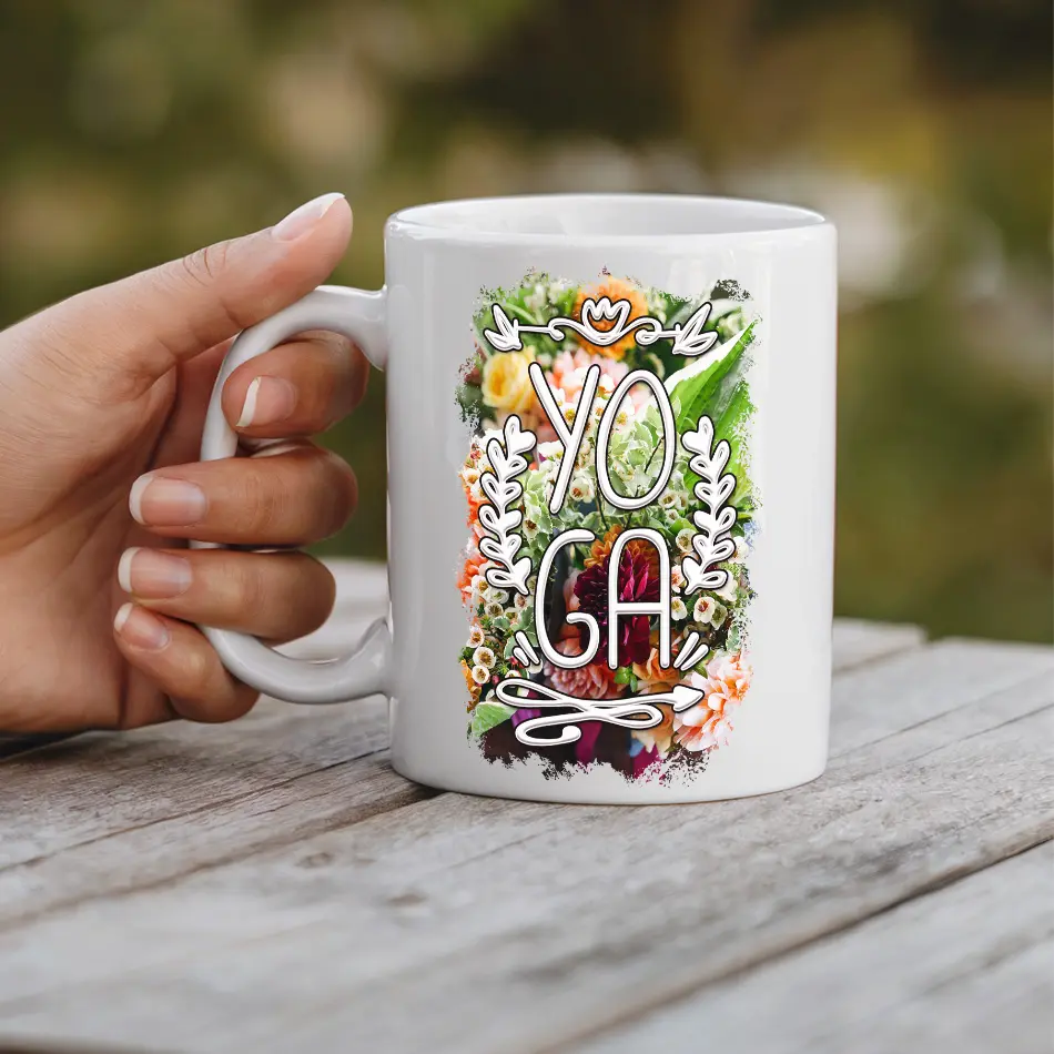 White ceramic mug with a vibrant floral design and the word "YOGA" in white lettering.