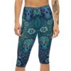 Blue Sugar Skull Capri Leggings featuring a Day of the Dead floral yoga pattern. The form-fitting capri leggings display intricate teal and dark blue sugar skulls, light blue flowers, and swirling botanical motifs on a smooth, snug fabric.