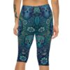 A person wears blue capri leggings featuring a pattern of sugar skulls and floral designs.