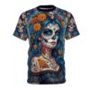Vibrant marigolds and blue calavera skulls pop on this sublimation print tee, detailed with ornate lace textures and a delicate skull pendant charm.