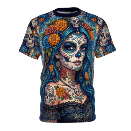 Vibrant marigolds and blue calavera skulls pop on this sublimation print tee, detailed with ornate lace textures and a delicate skull pendant charm.