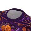 Vibrant purple marigolds and sugar skulls create a seamless pattern that covers every inch of this vibrant graphic tee for a bold Day of the Dead display.