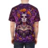 Vibrant purple La Catrina sugar skulls and marigolds showcase a 360-degree graphic that flows seamlessly across the entire surface of this t-shirt.