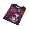Embrace this 360-degree graphic tee showing vibrant purple Catrinas, orange marigolds, and gold jewelry on a soft, smooth fabric.
