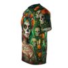 This soft tee displays a vibrant 360-degree graphic of marigolds, teal hair, and sugar skulls against a dark, ornate green floral backdrop.
