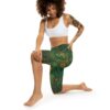 Green capri leggings with intricate Day of the Dead sugar skull and floral patterns in vibrant orange and yellow accents.