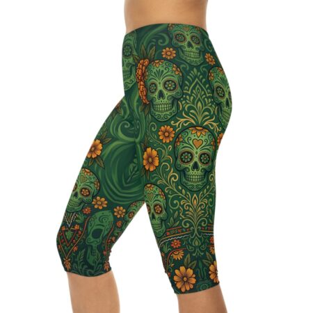 Green capri leggings with a detailed Day of the Dead floral sugar skull pattern in orange and gold.