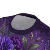 Vibrant purple skulls and floral motifs saturate this gothic t-shirt through a seamless pattern that covers every inch of the fabric from collar to hem.
