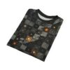 A black t-shirt with a complex, all-over print featuring geometric shapes, circuitry patterns, and glowing orange accents.