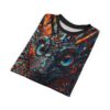 Folded t-shirt displaying a colorful mosaic art print of a cat face with bright blue eyes on a dark background.