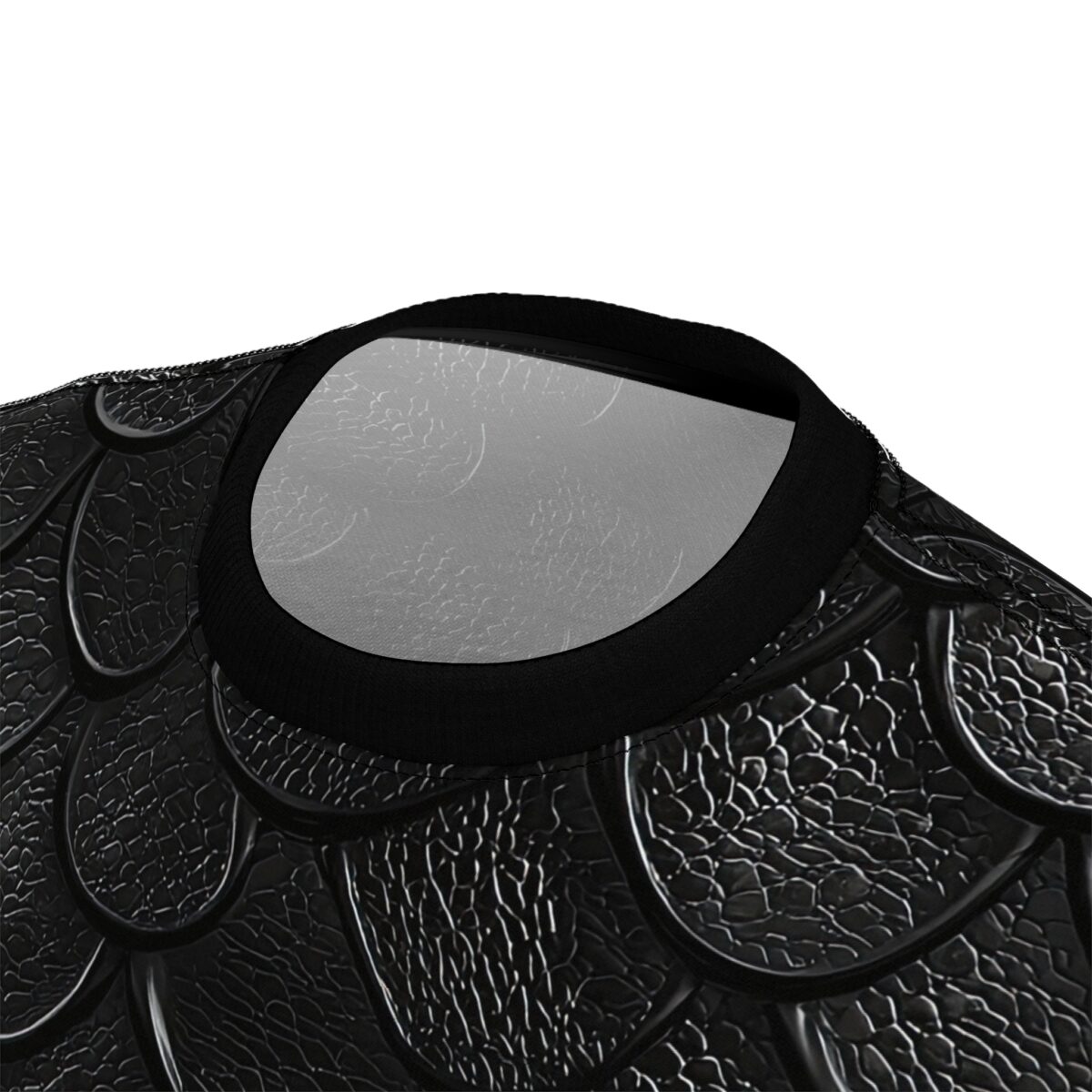 Close up of a black t-shirt collar featuring an embossed 3D dragon scale texture.