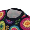 Embroidered floral all over print sublimation tee featuring vibrant, colorful, circular patterns on a dark background.
