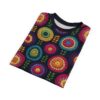 Crocheted floral all over print t-shirt featuring vibrant colorful circular motifs and green leaves on a dark background.