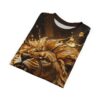 Folded black and gold t-shirt featuring a detailed artistic illustration of a snarling lion with liquid gold accents.