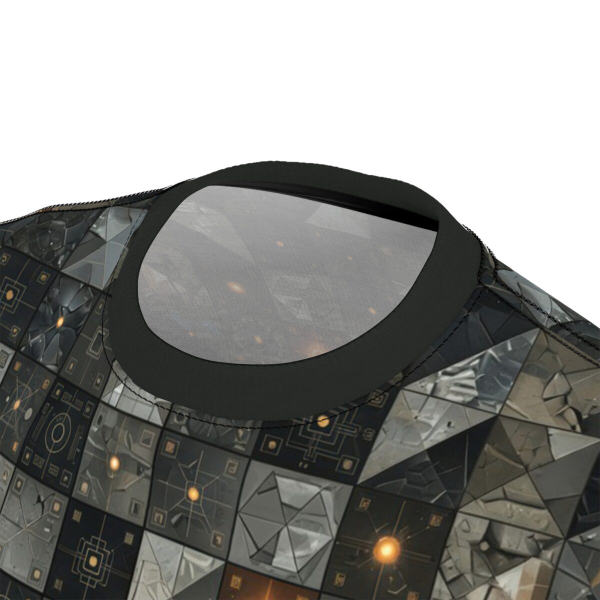 Close up of a dark t-shirt with a repeating geometric sci-fi pattern featuring metallic textures and glowing orange lights.