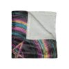Plush throw blanket featuring an abstract geometric design with colorful curved lines and a central triangle symbol. Cozy home decor.