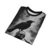 Black t-shirt with a detailed raven perched on a human skull graphic, set against a grunge-style textured background.