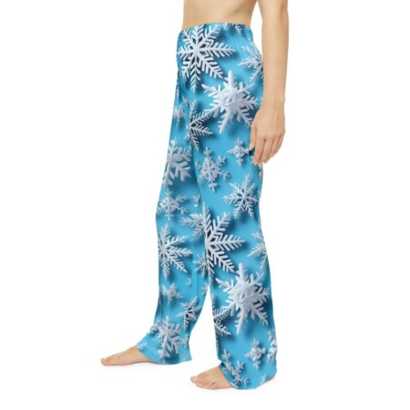 All over print pajama pants featuring a seamless pattern of white snowflakes on a bright blue background.