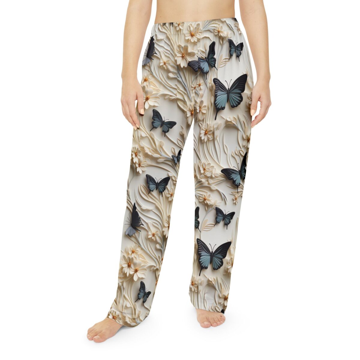 Cream pajama pants with an all-over print of dark blue butterflies and raised floral details, showcasing a seamless wrap-around graphic.