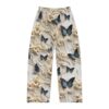 White pajama pants with all over print of blue butterflies and raised floral details.