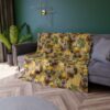 Cozy throw blanket featuring a seamless pattern of capybaras wearing lemon wreaths and surrounded by citrus slices and flowers on a gold textured background.